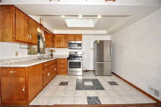 1011 Greenock Buena Vista Rd, Elizabeth Twp/Boro, PA 15135 - kitchen featuring stainless steel appliances, a sink, brown cabinetry, and light countertops