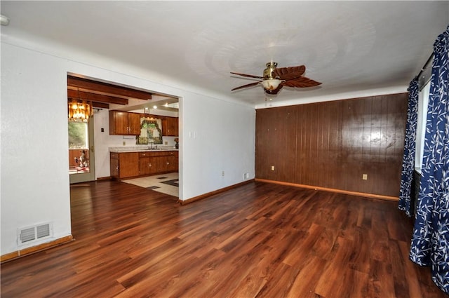 1011 Greenock Buena Vista Rd, Elizabeth Twp/Boro, PA 15135 - unfurnished living room with ceiling fan, wood walls, wood finished floors, baseboards, and a chandelier