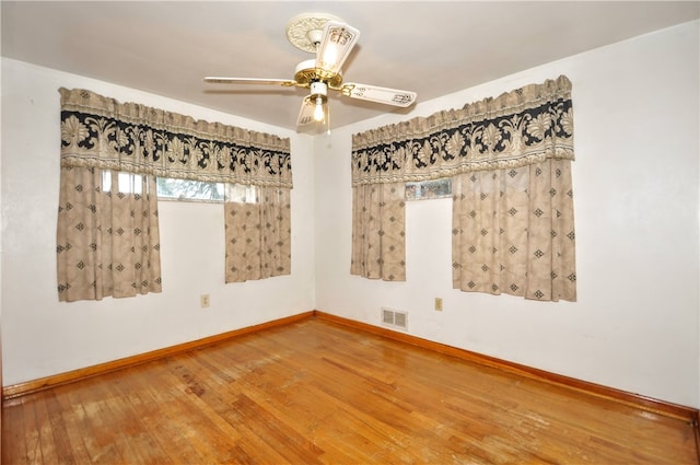 empty room featuring ceiling fan and wood-type flooring