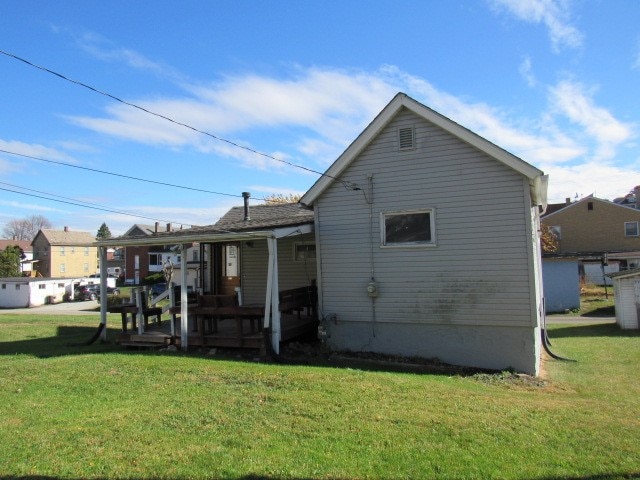 rear view of property with a lawn