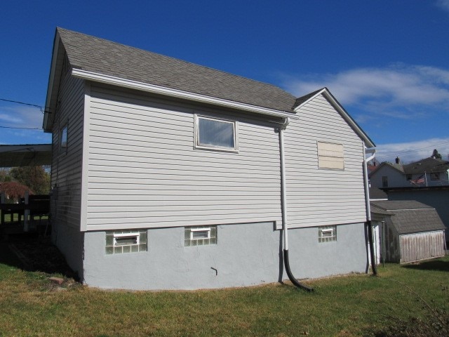 view of side of property with a yard