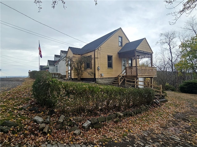 view of property exterior with a wooden deck