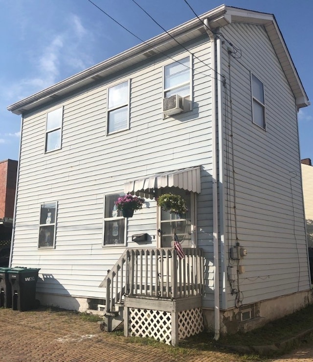 back of house featuring cooling unit