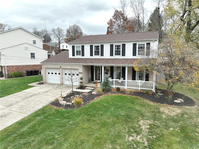 view of front of property with a garage, a porch, and a front lawn