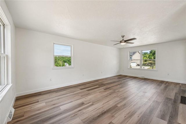 spare room with ceiling fan and light hardwood / wood-style flooring