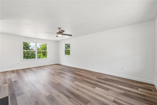 spare room featuring ceiling fan and light hardwood / wood-style floors