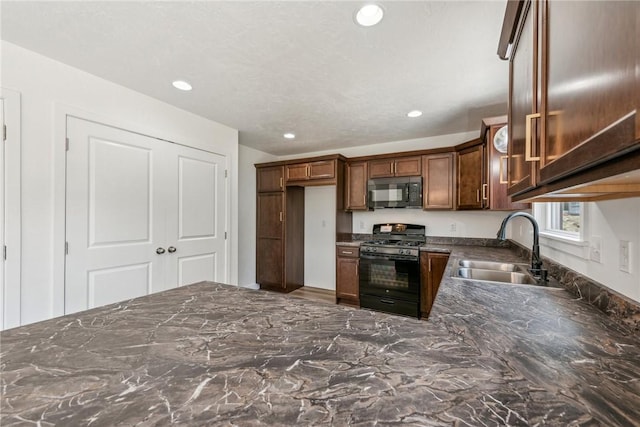 kitchen with sink and black appliances