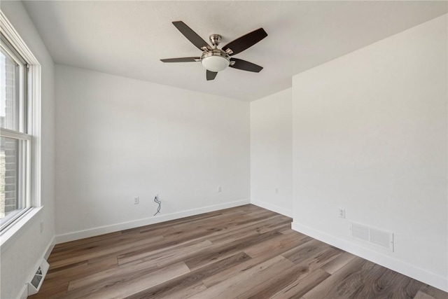 unfurnished room with ceiling fan and wood-type flooring