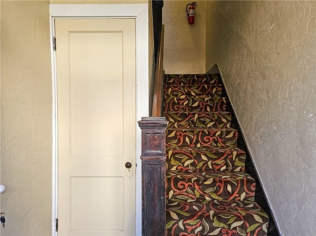 stairway with a textured wall