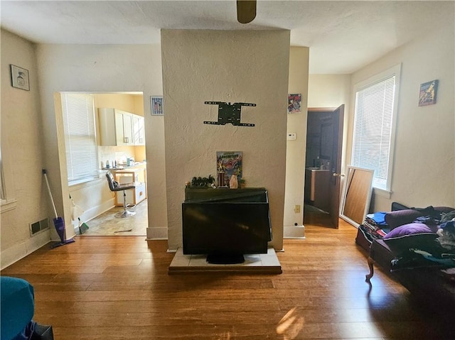 living area with hardwood / wood-style flooring and baseboards