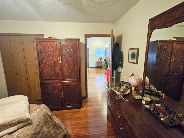 bedroom with wood finished floors and a textured ceiling