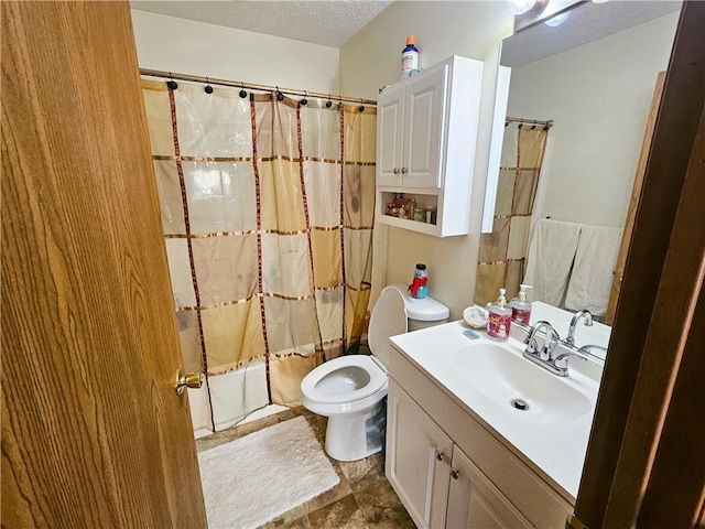 full bathroom with vanity, toilet, a textured ceiling, and stone finish flooring