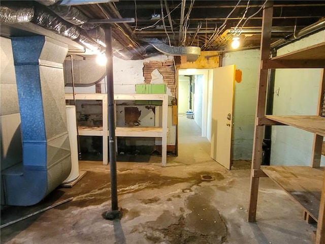 unfinished basement featuring water heater