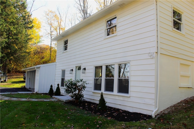 back of house with a lawn