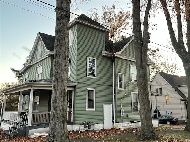 back of property featuring a porch