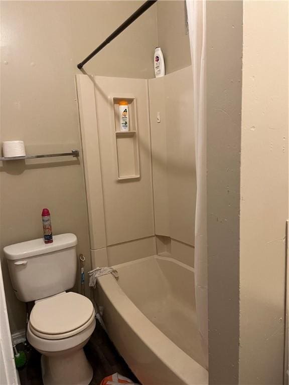 bathroom with toilet and shower / tub combo with curtain