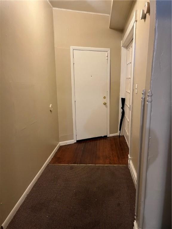 corridor with dark hardwood / wood-style flooring