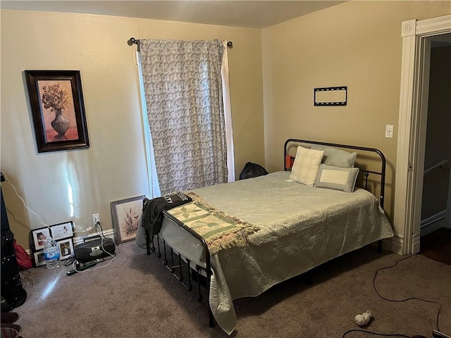 bedroom featuring dark colored carpet