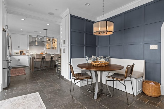 dining space featuring breakfast area and crown molding