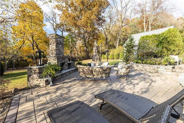 view of patio featuring an outdoor living space with a fireplace