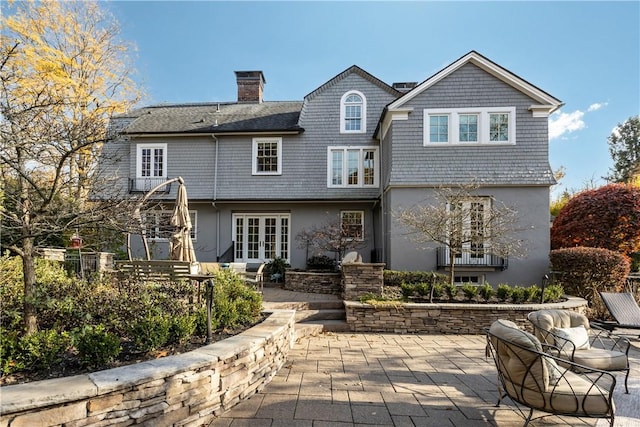 rear view of property with french doors and a patio