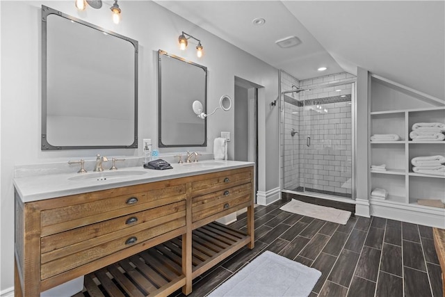 bathroom featuring a shower with door and vanity