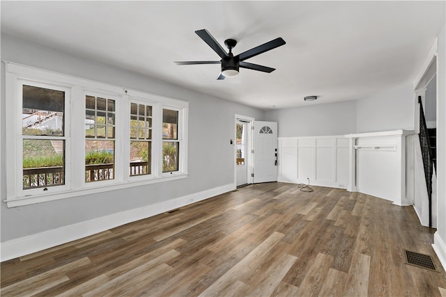 unfurnished living room with hardwood / wood-style flooring and ceiling fan