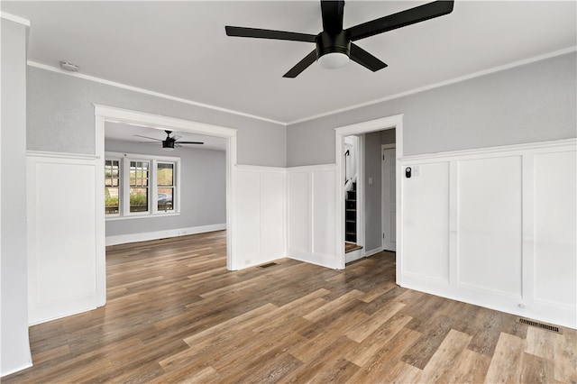 unfurnished room featuring hardwood / wood-style flooring, crown molding, and ceiling fan