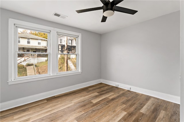 empty room with hardwood / wood-style flooring and ceiling fan