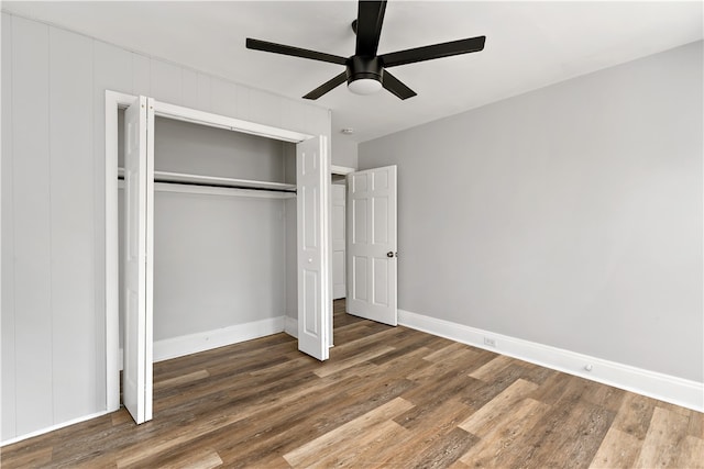 unfurnished bedroom featuring dark wood-type flooring, ceiling fan, and a closet