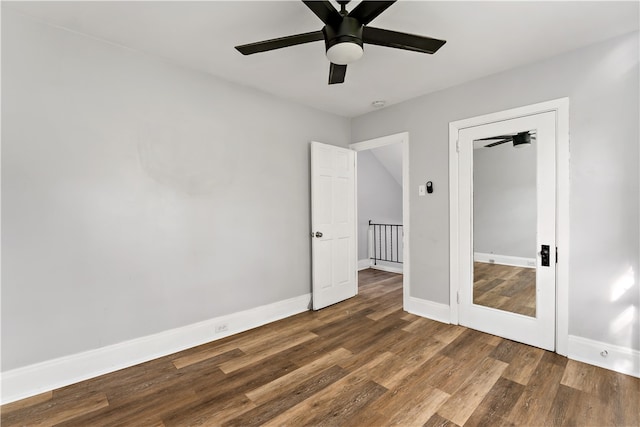 unfurnished bedroom featuring dark wood-type flooring and ceiling fan