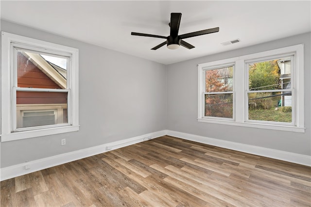 empty room featuring hardwood / wood-style flooring and ceiling fan