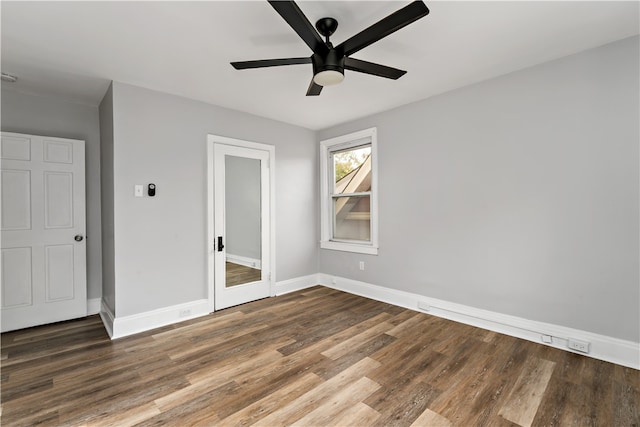 unfurnished bedroom featuring ceiling fan and dark hardwood / wood-style floors