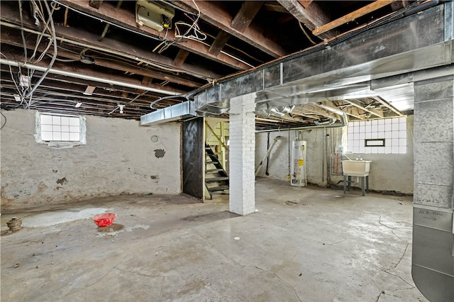 basement featuring gas water heater and sink