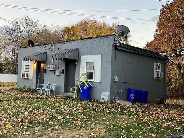 back of property featuring a yard and cooling unit