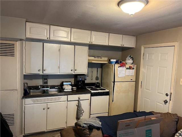 126 Park Ave, New Castle/2Nd, PA 16101 - kitchen with white appliances, dark countertops, white cabinets, under cabinet range hood, and a sink