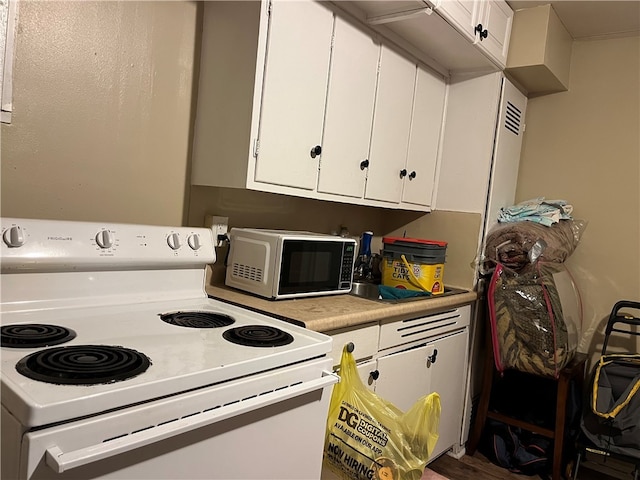 kitchen featuring white cabinetry and white electric stove