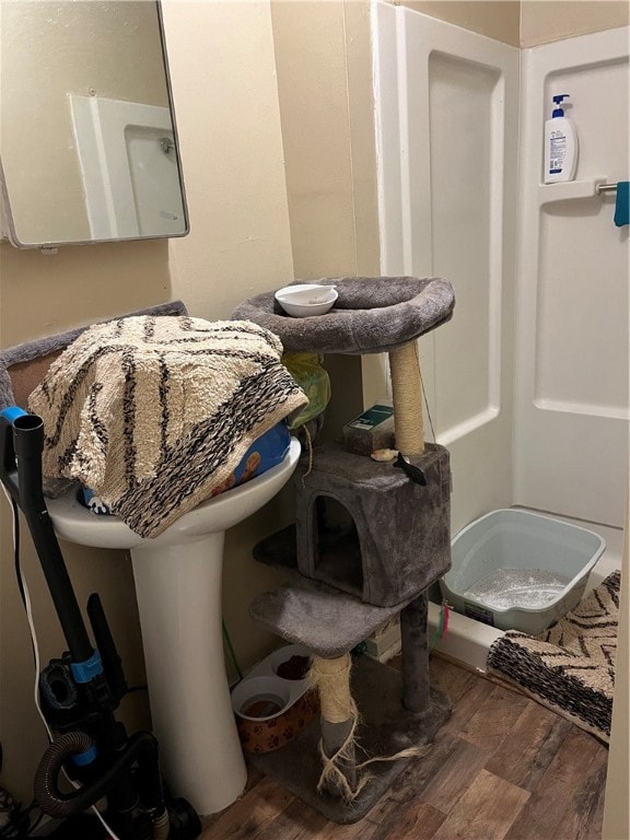 bathroom featuring a shower and hardwood / wood-style flooring