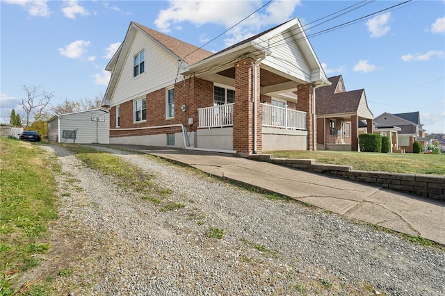 view of side of home featuring a yard and a porch