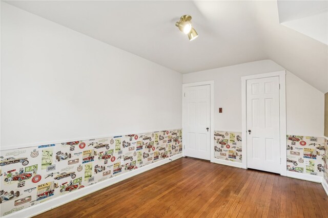 interior space featuring hardwood / wood-style floors and vaulted ceiling