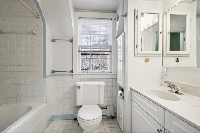 full bathroom with baseboard heating, tile patterned floors, toilet, vanity, and tile walls