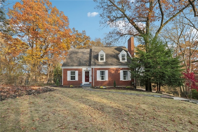 cape cod house with a front yard