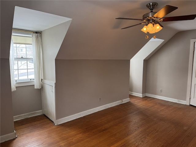 additional living space featuring dark hardwood / wood-style floors, ceiling fan, and lofted ceiling