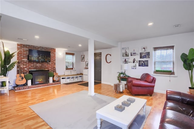 living room with wood-type flooring and a fireplace