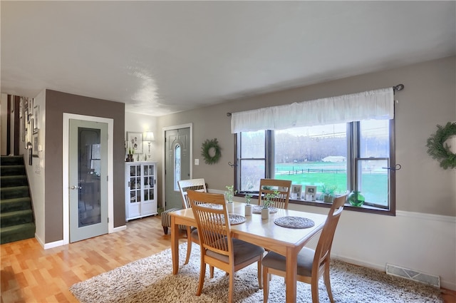 dining space with light hardwood / wood-style floors