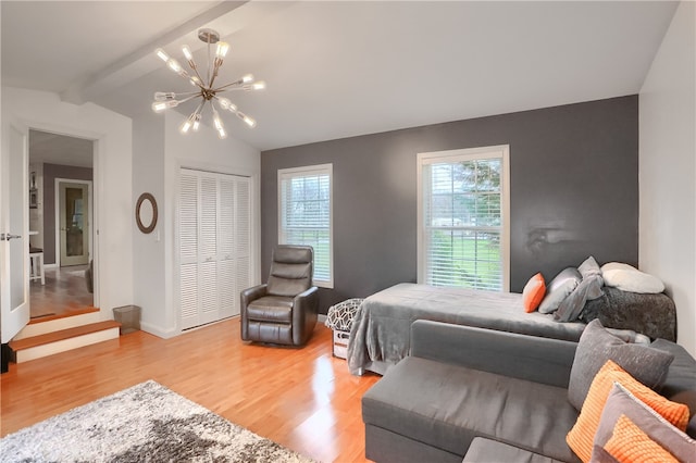 bedroom featuring vaulted ceiling with beams, hardwood / wood-style flooring, a closet, and a notable chandelier