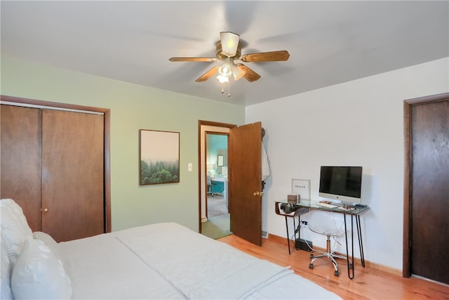 bedroom featuring ceiling fan, a closet, and light wood-type flooring