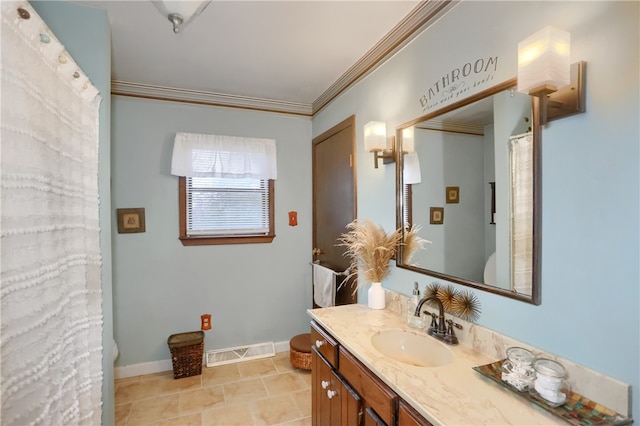 bathroom with tile patterned floors, crown molding, vanity, and toilet