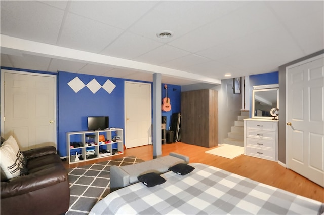 bedroom featuring ensuite bathroom and hardwood / wood-style flooring