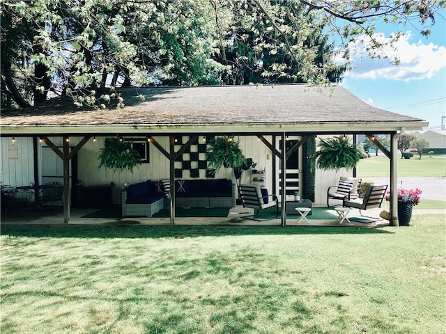 back of house with outdoor lounge area, a patio area, and a yard